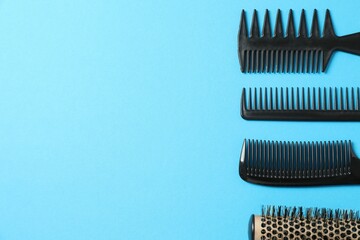 Professional combs and hairdresser tools on color background, top view