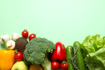 Clean healthy eating habits concept. Fruits, herbs, greens and vegetables mix, colorful juicy organic detox smoothie juice ingredients, color background. Vegan vegetarian diet food