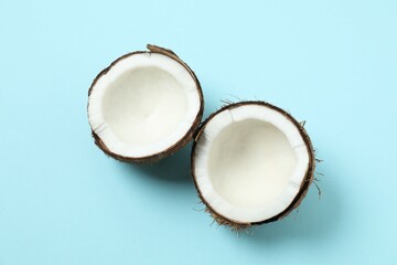 Coconuts on color background, top view