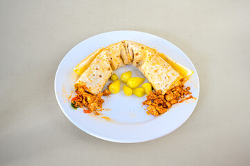 Meat, chicken shawarma kebab with yogurt and fried butter sauce .Tantuni Special. durum  Yogurtlu tantuni. Ekmek arasi tantuni. 