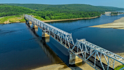Train traffic. Railway bridge and trains with wagons. Transportation industry	
