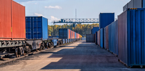 Transportation industry. Loading sea containers onto trains. Sorting railway station