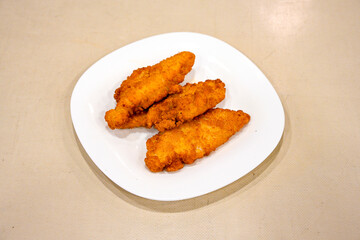 Homemade fried chicken nuggets isolated on white background. Chicken nugget. Citir tavuk. Citir, tavuk atistirma  tabagi.