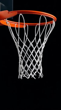 Basketball hoop suspended against a dark background showcases the thrilling aspect of the sport during late night games