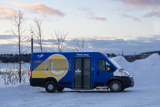 Quebec City, Quebec, Canada, February 8, 2025 - A parked on-demand transportation service Flexibus seen in a winter dawn landscape on the St. Lawrence river shore