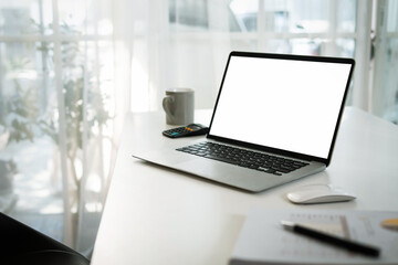 White screen laptop mockup Place a work desk next to the window.