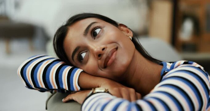 Thinking, smile or woman on living room sofa for peace, daydreaming or nostalgia to remember memory. Break, girl and happy Indian person on couch to relax in house for vision of ideas or inspiration