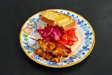 Close-up shot of Izmir's famous Turkish Traditional Kumru Sandwich, Ceşme Kumru, patso ingredients ready to eat salami, soudjouk, tomato, cheddar cheese and fried cheese. Yengen sandvic. Izmir karisik