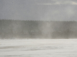 heavy snowfall with wind gusts making a hazy air