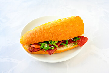 Close-up shot of Izmir's famous Turkish Traditional Kumru Sandwich, Ceşme Kumru, patso ingredients ready to eat salami, soudjouk, tomato, cheddar cheese and fried cheese. Yengen sandvic. Izmir karisik