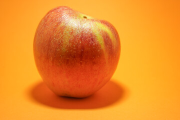 Apple isolated on orange background