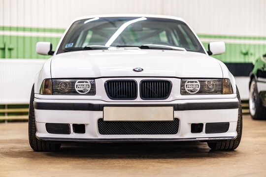 Riga, Latvia - January 31, 2025: A stunning front view of a classic white BMW E36 that beautifully showcases its iconic and timeless design