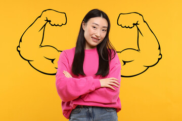 Beautiful woman with drawing of strong arms behind her on orange background