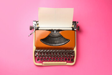 Vintage typewriter with sheet of paper on pink background, top view