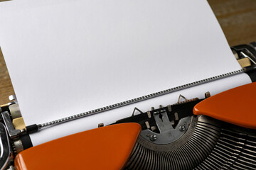 Vintage typewriter with sheet of paper on table, closeup. Space for text