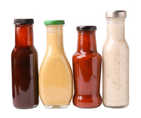 Different delicious sauces in glass bottles isolated on white