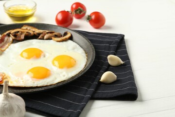 Tasty fried eggs with mushrooms served on white wooden table, closeup. Space for text