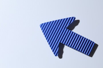 One blue paper arrow on white background, top view. Space for text