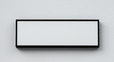 Empty black frame on white wall