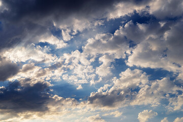 Epic Dramatic storm dark grey violet cumulus rain clouds against blue sky background texture, thunderstorm