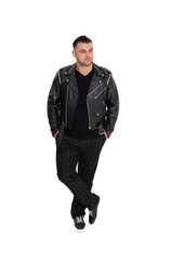 Naklejka premium A handsome dark-haired man in a black leather jacket, black T-shirt, trousers and sneakers on a white background