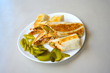 Lavash doner kebab ( soslu kasarli zurna doner durum )  or shawarma sliced in plate isolated.  Tavuk Et Doner Durum. Hatay Iskenderun usulu bazuka tavuk doner durum. 