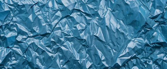 Obraz premium Close-up of crumpled sky blue metal texture with a shiny, metallic, icy surface