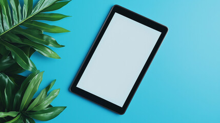 touch screen blank tablet screen  isolated on  blue background and  green leaves next ton it 