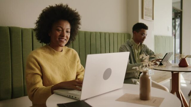 African American woman typing out a work essay