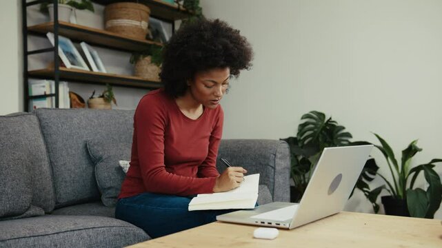 African American university student making notes for herself to help her understand the work better