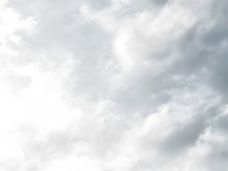 Naklejka premium Cloudy Sky: Soft, diffused light filters through a blanket of fluffy cumulus clouds, creating a serene and ethereal atmosphere.