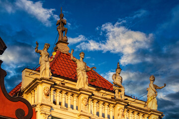 Beautiful ancient house in Gdansk. Medieval statues of antique gods on the roof	