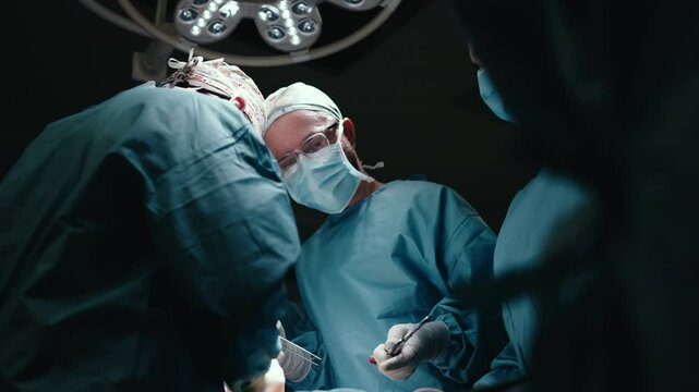 A team of professional surgeons performs surgery in a modern hospital. Concept: skills working using the latest technology in cardiology and transplantation.