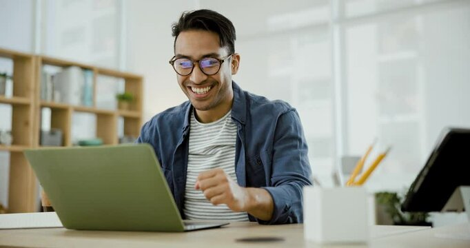 Happy asian man, laptop and fist pump in celebration for winning, success or good news at office. Excited male person or creative employee in achievement, bonus or startup promotion at workplace