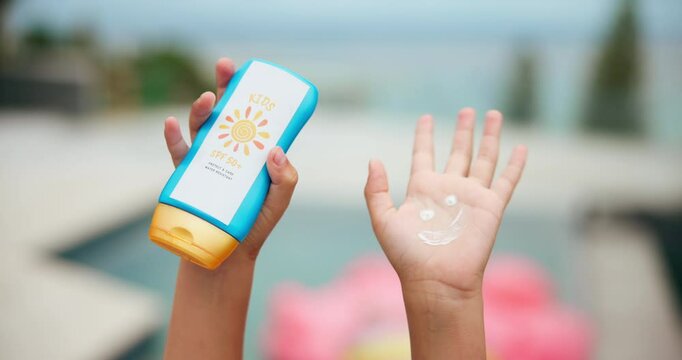 Closeup, kid and hands with sunscreen outdoor of skincare protection, prevent sunburn and summer holiday. Kid, bottle and cream with smile for facial wellness, spf treatment and dermatology hydration