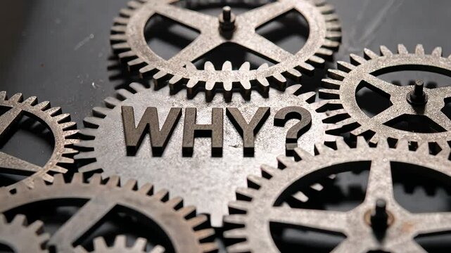 5 WHY analysis concept, Gears with the word WHY in focus.