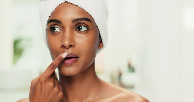 Beauty, natural and woman with lip balm in home for cosmetics, skincare products or oils. Apply, house and Indian girl model in bathroom thinking of mouth care for routine, treatment or moisturiser