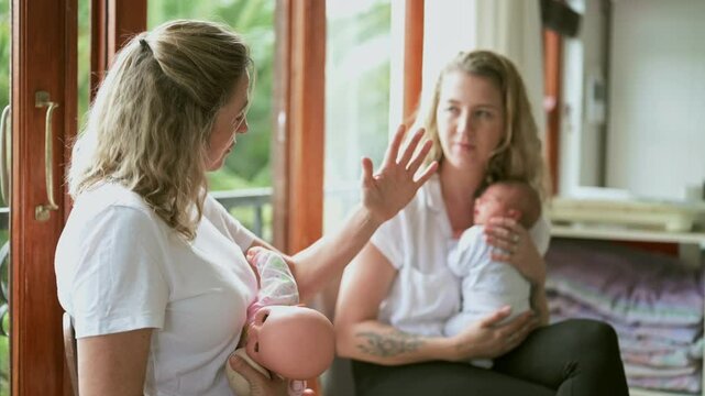 Baby class, breastfeeding and a nurse with a parent in her home for prenatal education or wellness. Healthcare, medical and midwife teaching a mother how to feed her newborn infant in a health clinic