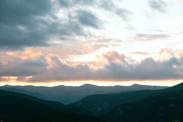 Fototapeta premium Glowing Clouds at Sunset Over Rocky Mountains