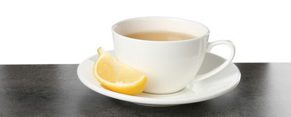 Refreshing green tea in cup and slice of lemon on grey textured table against white background. Space for text