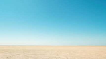 Naklejka premium Vast Desert Landscape Under Clear Blue Sky with Soft Horizon