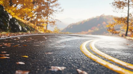 Serene autumn road winding through vibrant foliage with mountains in the background