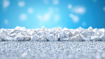 Obraz premium White stones on asphalt, blue sky background