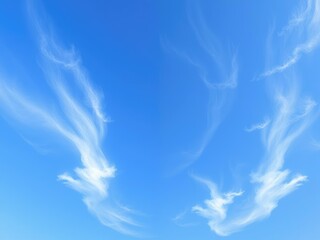 Delicate cirrus clouds in wispy tendrils stretching across a clear blue sky, creating a sense of movement and energy, abstract, cloud formations