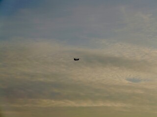 Helicopter fly on sunset lights near the coast of the Saronic Gulf in the Athens Riviera, Piraeus, Greece