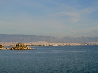 View of the seaside and Hymettus or Hymettos, a mountain range in the Athens area of Attica, from the Votsalakia beach, Piraeus, Greece