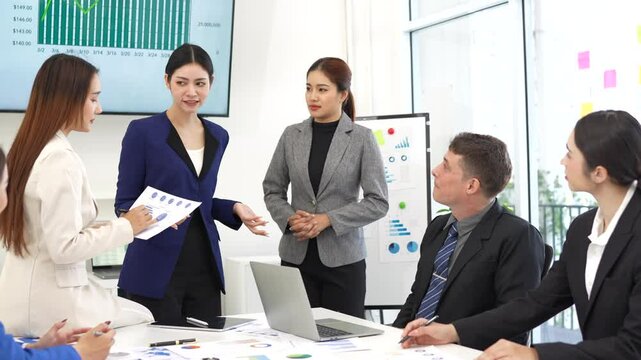  Group of business people standing near a table. Young business team working together on a modern project.