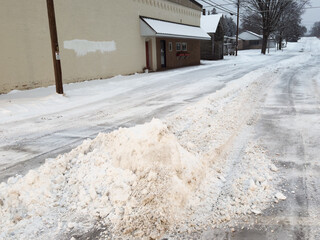 A pile of plowed snow in the street