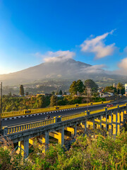 View of the bridge with the mountain in the background. Sigandul Bridge and Mount Sumbing.