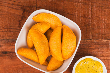 Colombian empanada with spicy sauce